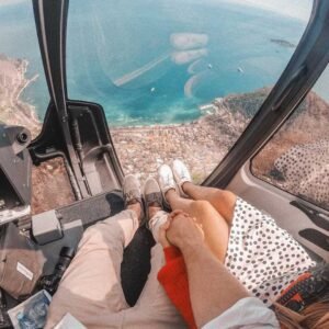 Private helicopter tour flying over Tijuana Mexico coastline and Baja California scenic highway at sunset